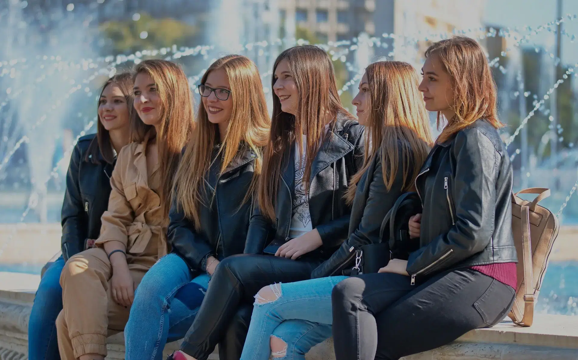 background photo of a group of women sitting together